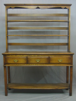 A 20th Century oak dresser with moulded cornice and raised open back fitted 2 shelves, the base fitted 3 drawers above a potboard, 54"