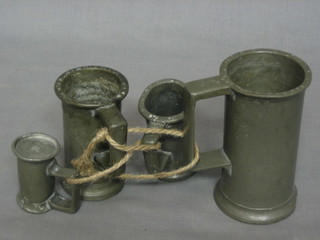 A set of 4 18th/19th Century graduated pewter spirit measures of cylindrical form (all with proof marks)