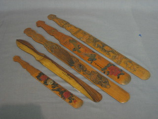 An olive wood newspaper opener and 4 Eastern carved hardwood letter openers