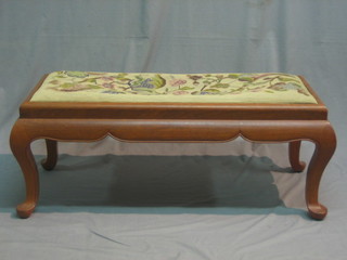 A rectangular Eastern hardwood stool with Berlin wool work seat, raised on cabriole supports 41"