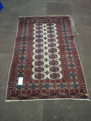 A white and red ground Bokhara rug with 22 octagons to the centre 62" x 37"