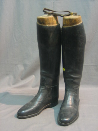 A pair of black leather riding boots complete with wooden trees