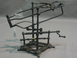 A bronze wine bottle stand and pourer