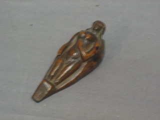 A carved wooden figure of a reclining naked lady 3"