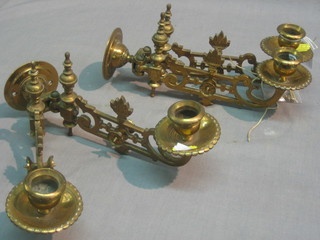 A pair of brass twin light candle sconces on pierced brackets