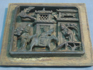 A carved Oriental panel depicting figures 5" x 6", the reverse with script