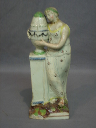 An 18th Century Staffordshire figure of a standing lady with urn (f and r) 9"