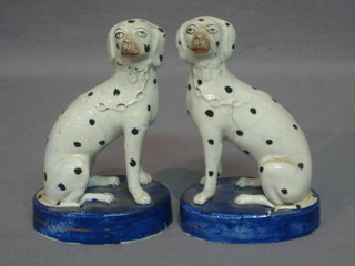 A pair of 19th Century Staffordshire figures of seated Dalmatians (1 heavily f), 5"