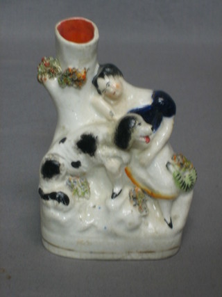 A 19th Century Staffordshire spill vase in the form of a reclining girl and dog 5"
