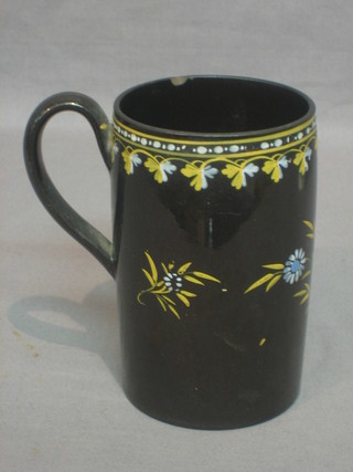 An 18th Century black glazed pottery mug with floral decoration 5"