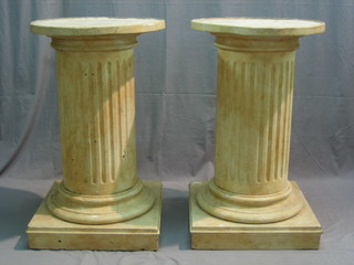A pair of fluted pedestal columns raised on square bases 35"