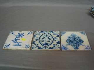 A blue and white Delft tile decorated a daffodil and 2 others