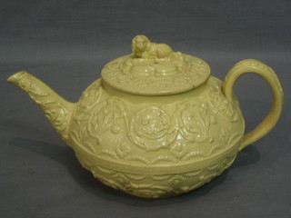 An 18th/19th Century Wedgwood Creamware teapot with embossed body, the finial in the form of a seated dog (lid f)
