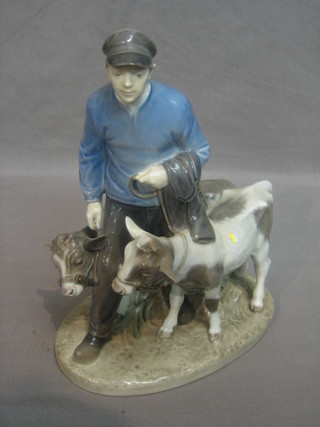 A Royal Copenhagen figure of a standing cowman with 2 cows, the base marked 1858 9"