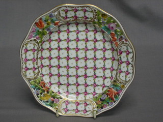 A circular Dresden ribbonware plate with floral decoration, the base with cipher marked DEC 299 DE/SOSE 7"