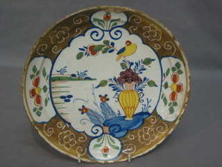 An 18th Century Delft plate with brown and blue banding decorated bird and vase 9" (large chip)