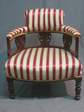 A Victorian walnut tub back chair upholstered in Regency stripe material, raised on turned supports 