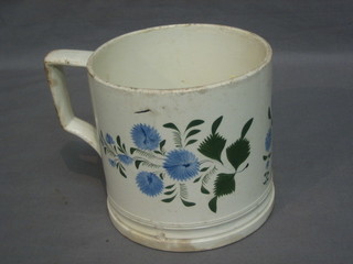 A large 19th Century pottery tankard with floral decoration 5"