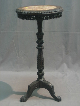 A carved padouk jardiniere stand with pink veined marble top, raised on carved pillar and tripod supports 15"