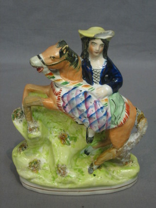 A 19th Century Staffordshire figure of a lady riding a horse side saddle (f and r) 6"