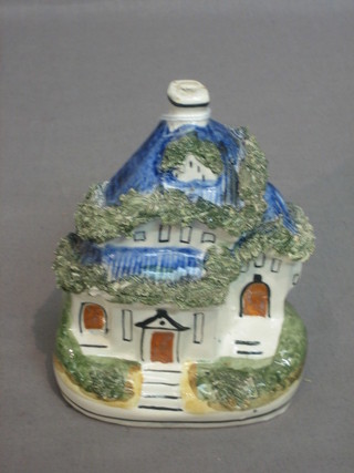 A Staffordshire figure of a cottage 4 1/2"