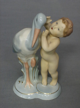 A Czechoslovakian figure of a standing child with stork 6 1/2"