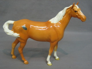 A Beswick figure of a standing Palomino horse 9"