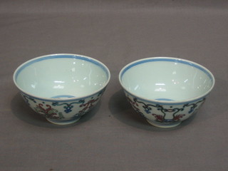 A pair of Oriental porcelain rice bowls with floral decoration, base with 6 character mark 4"