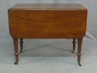 A 19th Century mahogany Pembroke table fitted a frieze drawer, raised on turned and fluted supports ending in brass caps and castors 35"