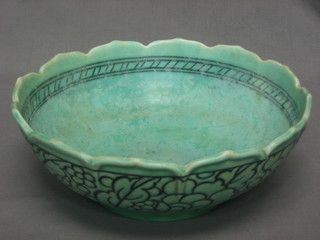 A circular green glazed Crown Ducal Charlotte Rhead Pottery bowl, the base with firing fault to centre  10"