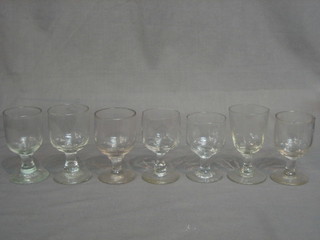 A collection of various antique wine glasses