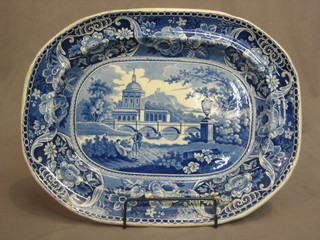 A 19th Century blue and white meat plate decorated park land with figures and temple 17"