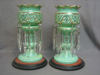 A pair of Victorian turquoise opaque glass lustres on turned ebony stands 14"