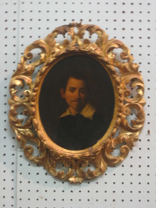 An 18th Century oil on board head and shoulders portrait of a gentleman, 8" oval contained in a carved gilt wood frame