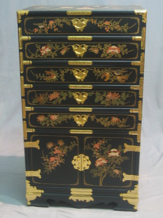 A 20th Century Eastern lacquered cabinet fitted 5 long drawers above a cupboard enclosed by a panelled door 21"