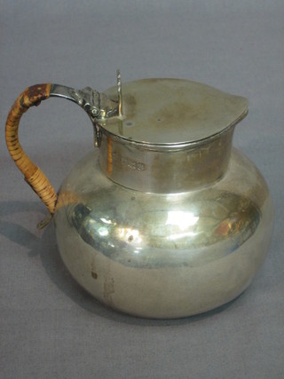 A silver hotwater jug in the form of a Jersey milk carrier, Sheffield 1928, 8 ozs