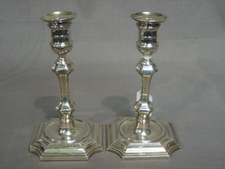 A handsome pair of Victorian Queen Anne style silver candlesticks with detachable sconces, raised on square shaped bases, Sheffield 1891 7 1/2"