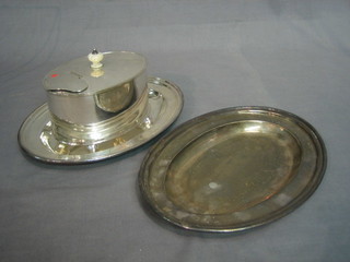 A 19th Century oval silver plated caddy raised on 4 bun feet and 2 oval plated platters 10"