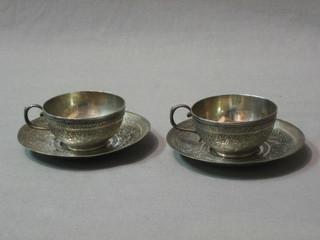 A pair of Persian "Qajar" engraved silver coffee cups and saucers, 7 ozs