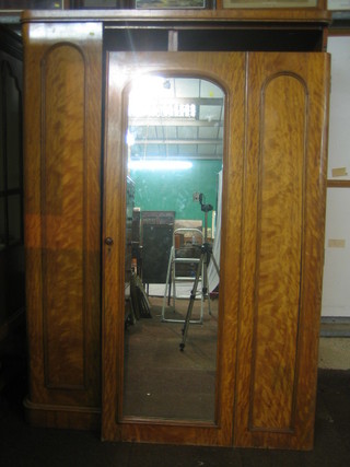 A Victorian satinwood wardrobe with fitted interior enclosed by arch shaped panelled, mirrored door 55"