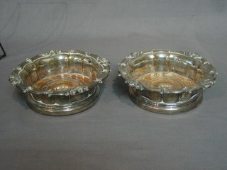 A pair of 19th Century circular embossed silver plated wine bottle coasters