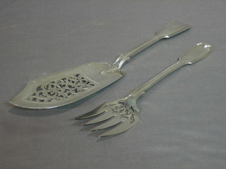 A pair of Victorian silver fiddle and thread pattern fish servers with armorial decoration, London 1853 10 ozs