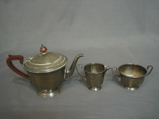 An Art Deco silver 3 piece bachelor's tea service comprising circular teapot, twin handled sugar bowl and cream jug, Birmingham 1947 and 1948 15 ozs
