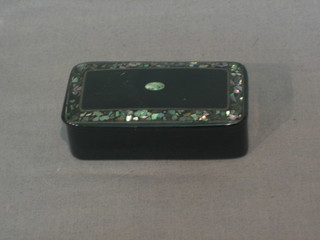 A Victorian lacquered snuff box with mother of pearl decoration