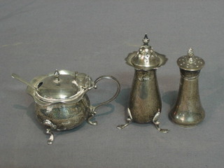 A silver mustard pot raised on 3 hoof feet complete with china liner, marks rubbed, a silver pepper Birmingham 1916 and 1 other silver pepper Birmingham 1905