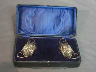 A pair of Edwardian embossed silver twin handled salts Birmingham 1905 1oz, boxed