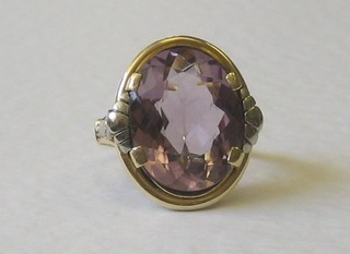 A gold dress ring set an oval cut amethyst