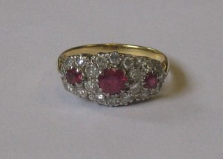 A 9ct gold cluster dress ring set 3 rubies supported by diamonds