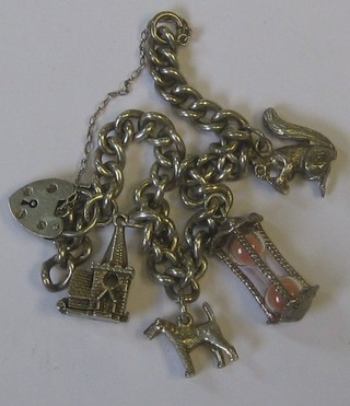 A  silver curb link bracelet hung 4 charms and with silver padlock clasp