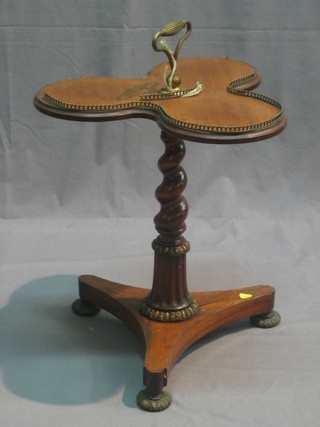 A William IV rosewood and walnut clover leaf table with walnut top and brass gallery, raised on a rosewood spiral turned column with triform base and gilt metal supports